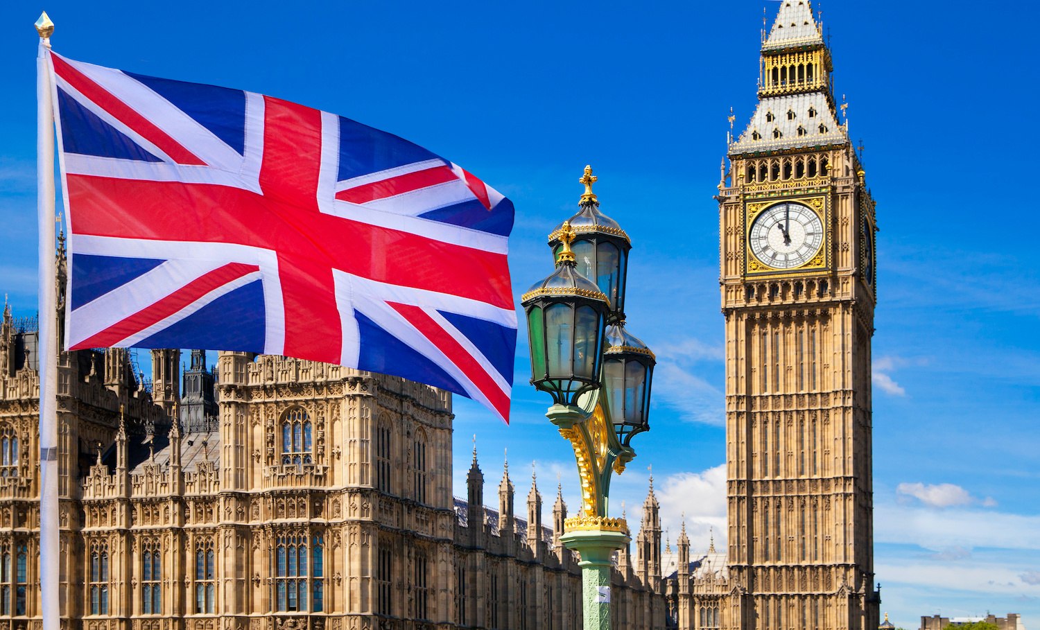 UK flag waving by Westminister Abbey and Big Ben