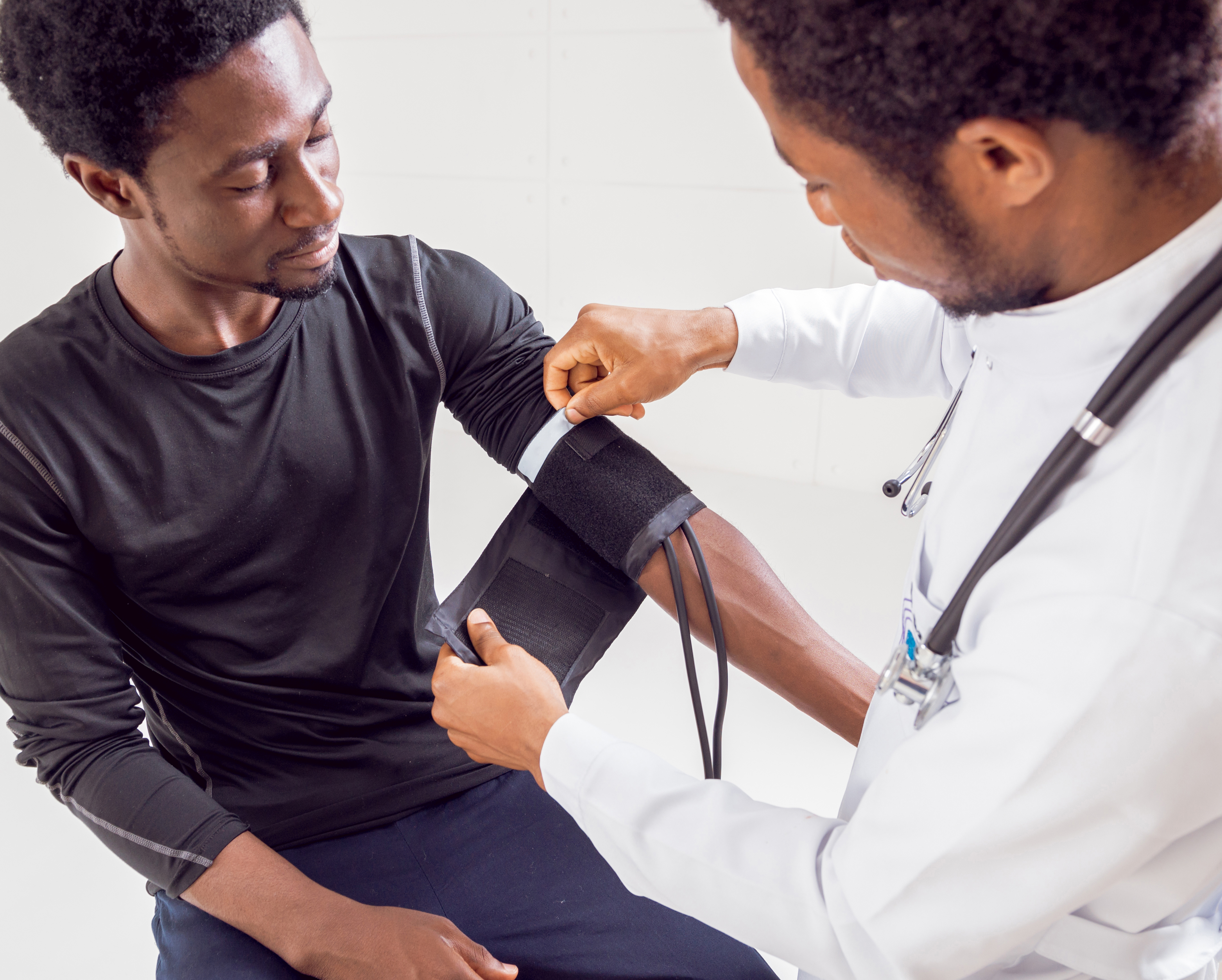 doctor and patient with blood pressure cuff