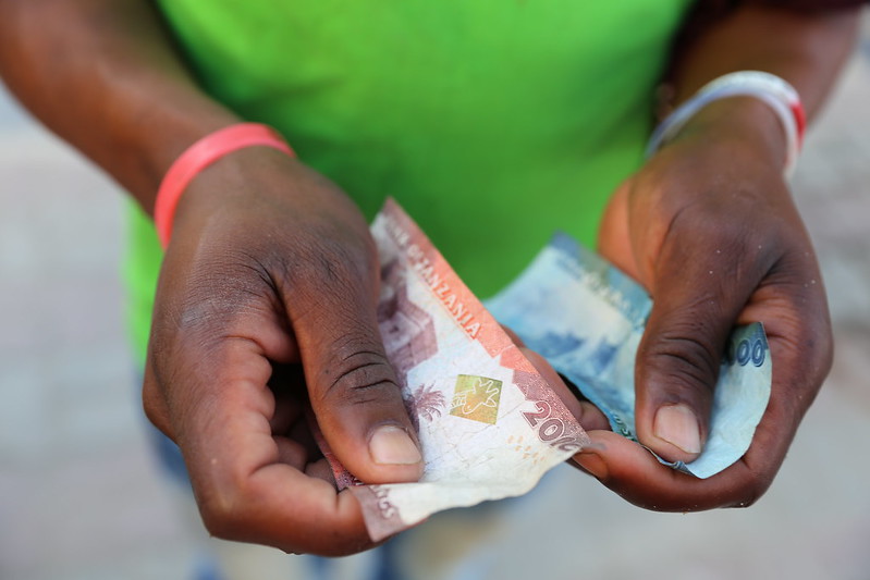 Hands holding Tanzanian shillings