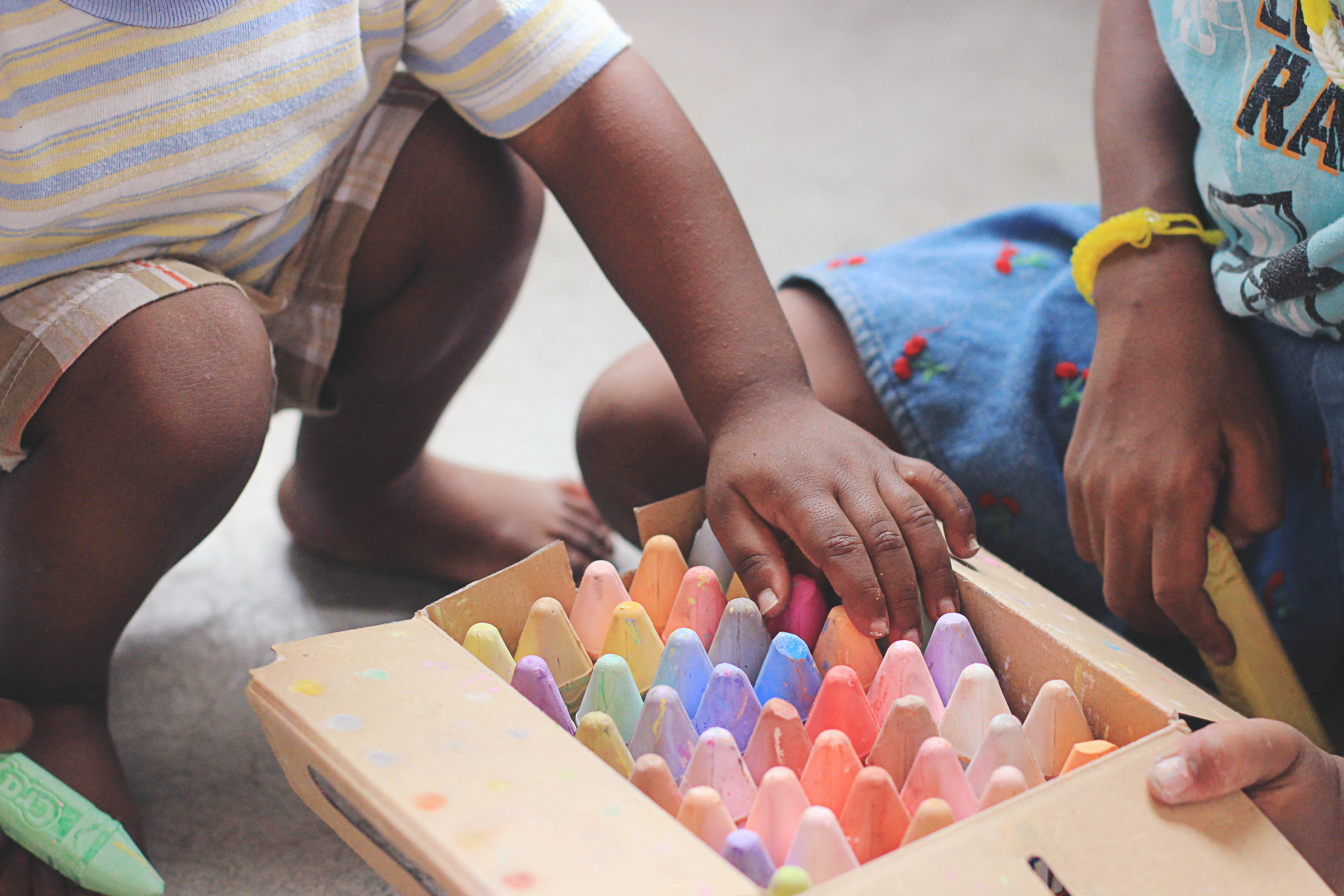 Child's hands with colored chalk