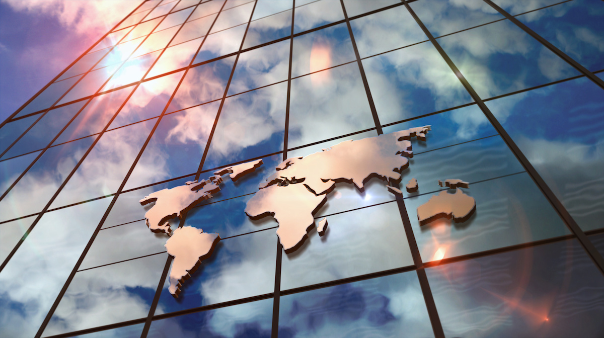 Stock photo of a world map on a glass skyscraper