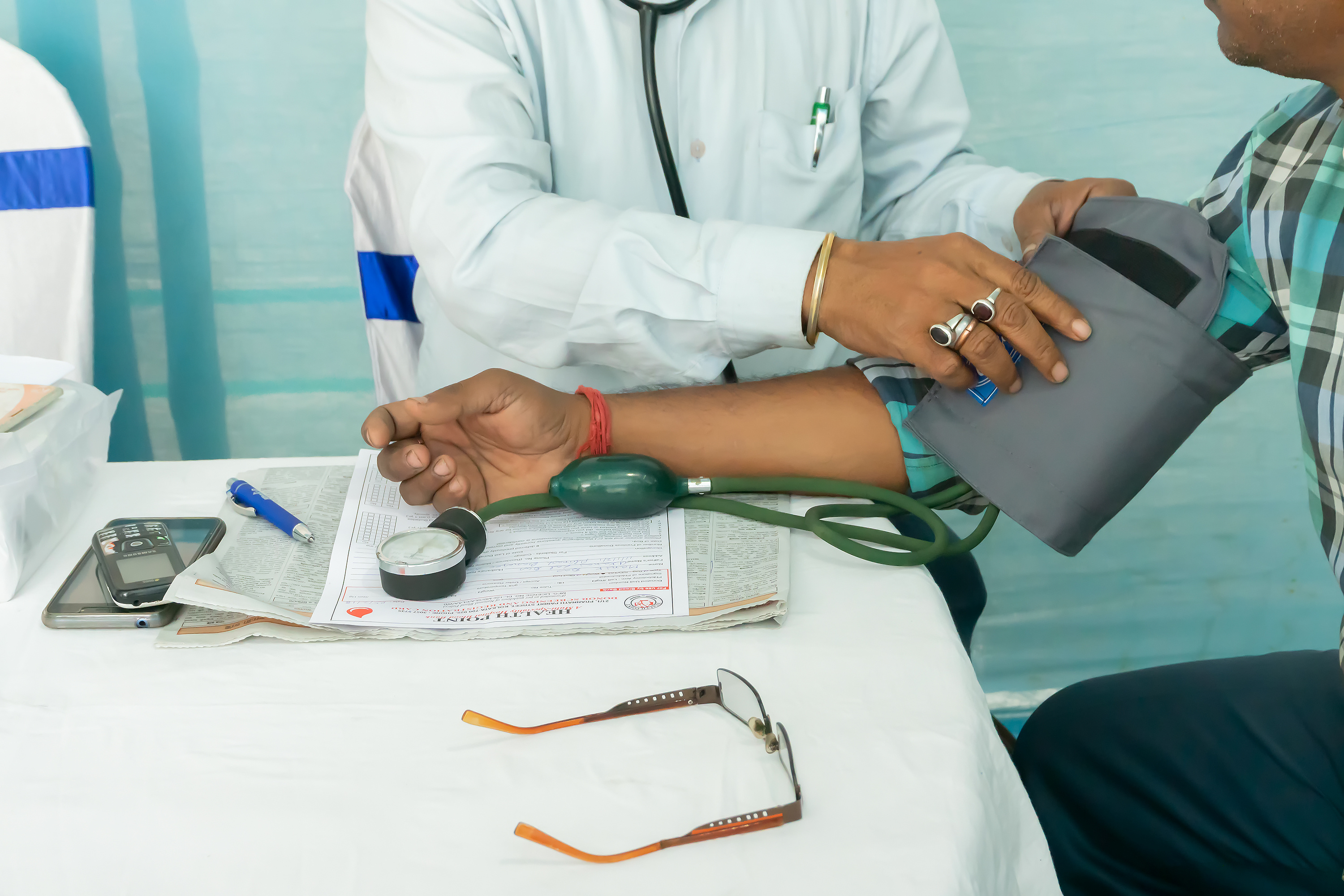 patient with blood pressure cuff on arm