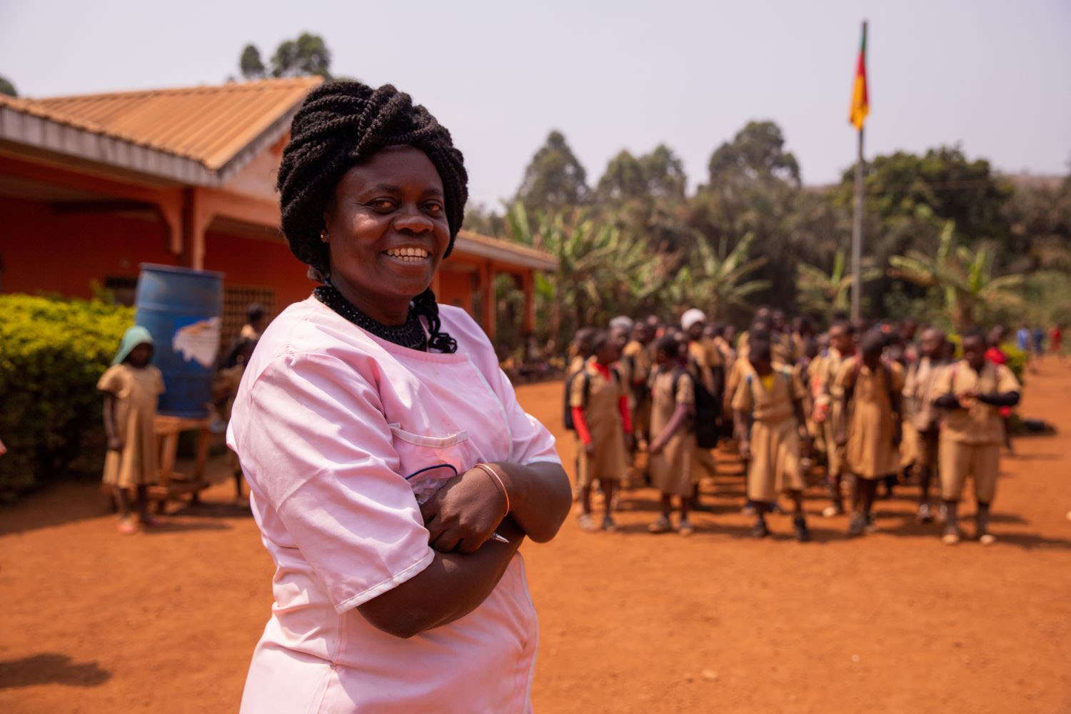 Portrait of an african school teacher with the pupils in the background out of focus