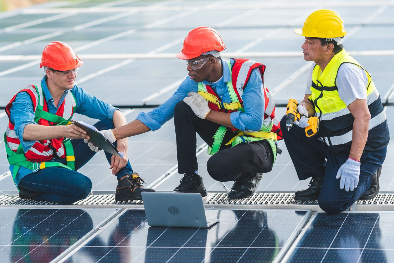 Technician engineer service meeting and checking solar cell on rooftop of industrial factory.