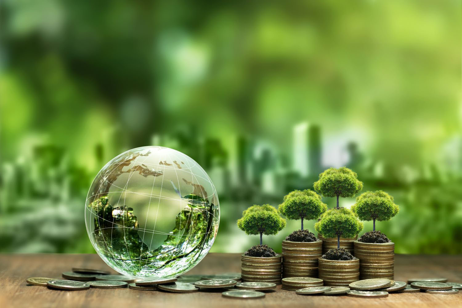 Tree on stack of silver coins and crystal globe Green business concept