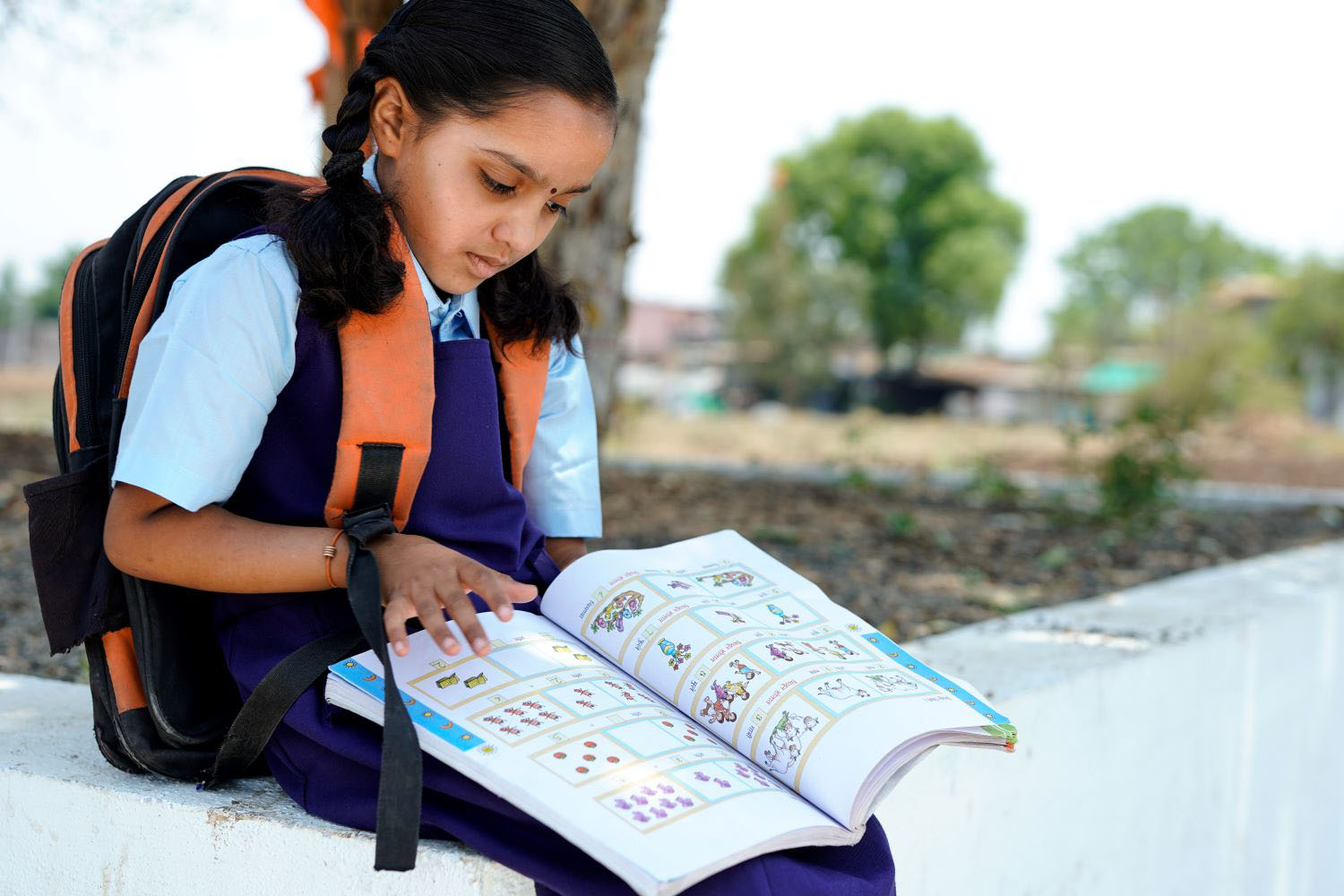 School girl reading textbook