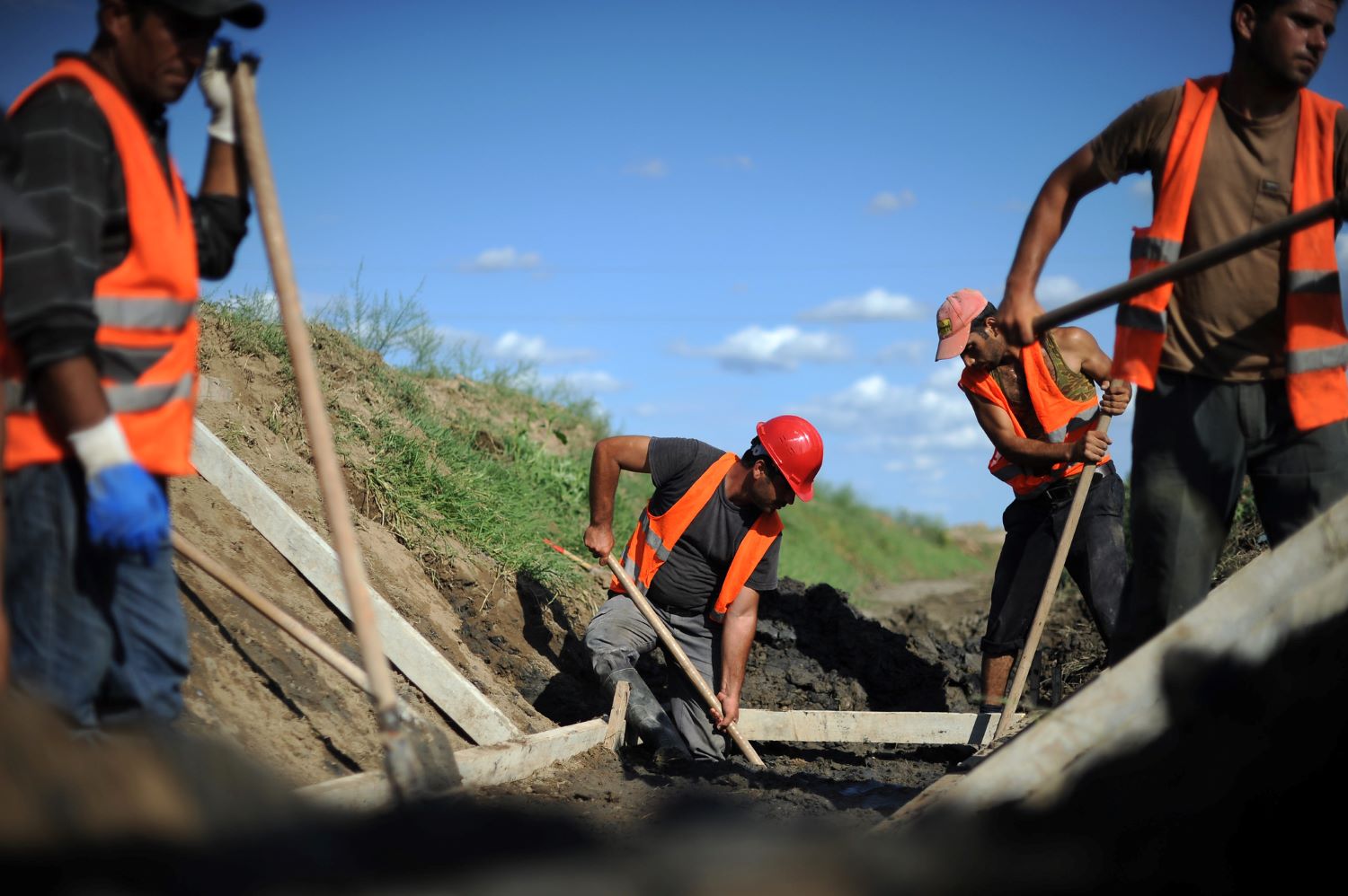 laborers digging trenches for water pipes