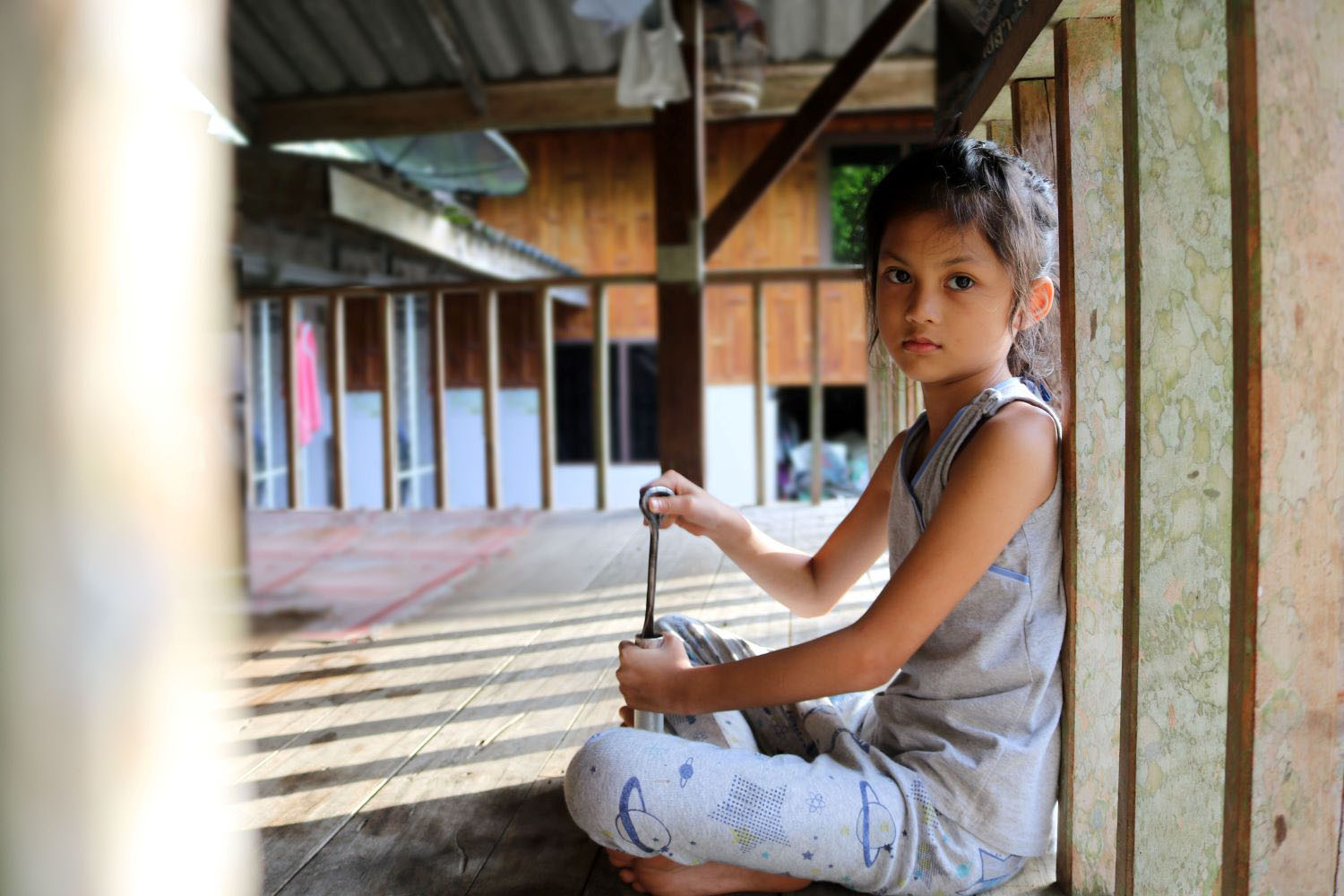 Young girl in local house in Thailand.