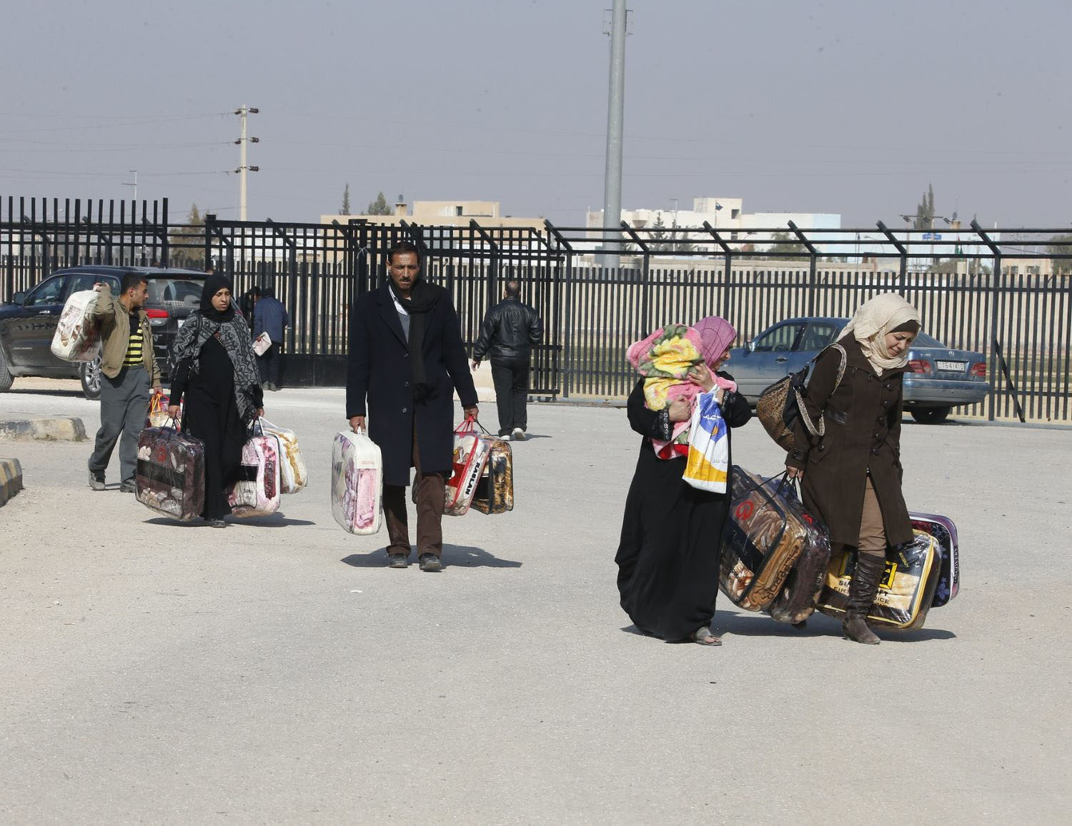 Syrian Refugees leave a blanket distribution center in Mafraq, Jordan. 