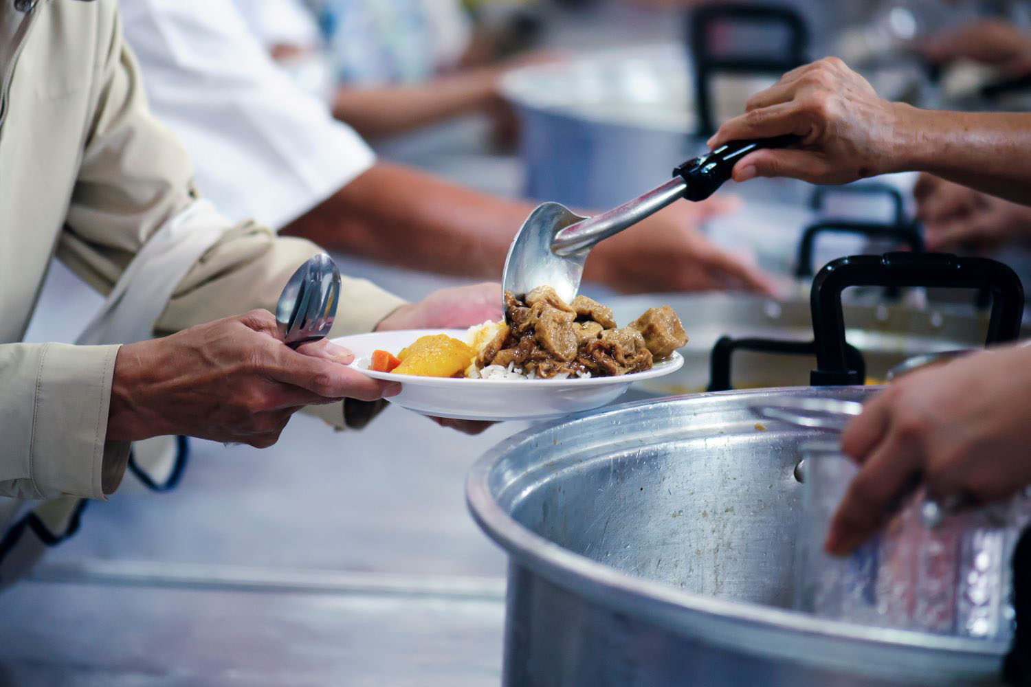 Meal being served at a soup kitchen