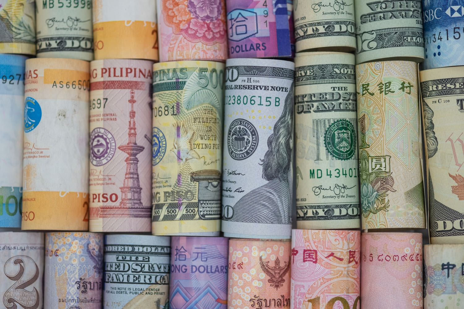 Closeup rolled of variety banknote around the world.