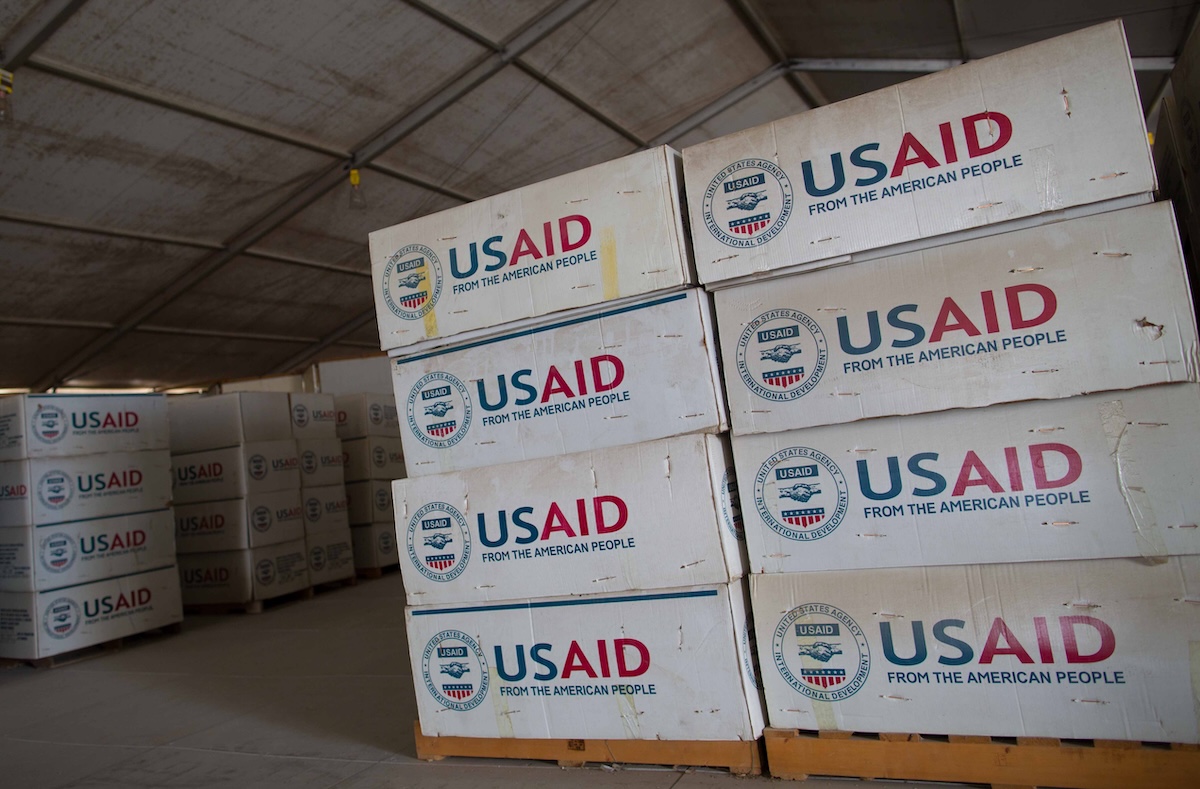 Stacks of USAID supplies in a warehouse