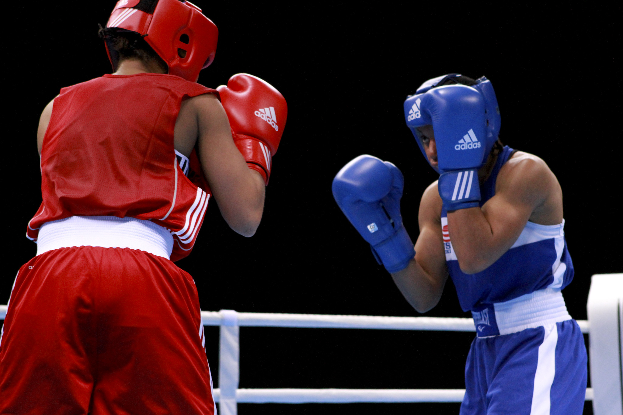 Two women boxing, one in red one in blue