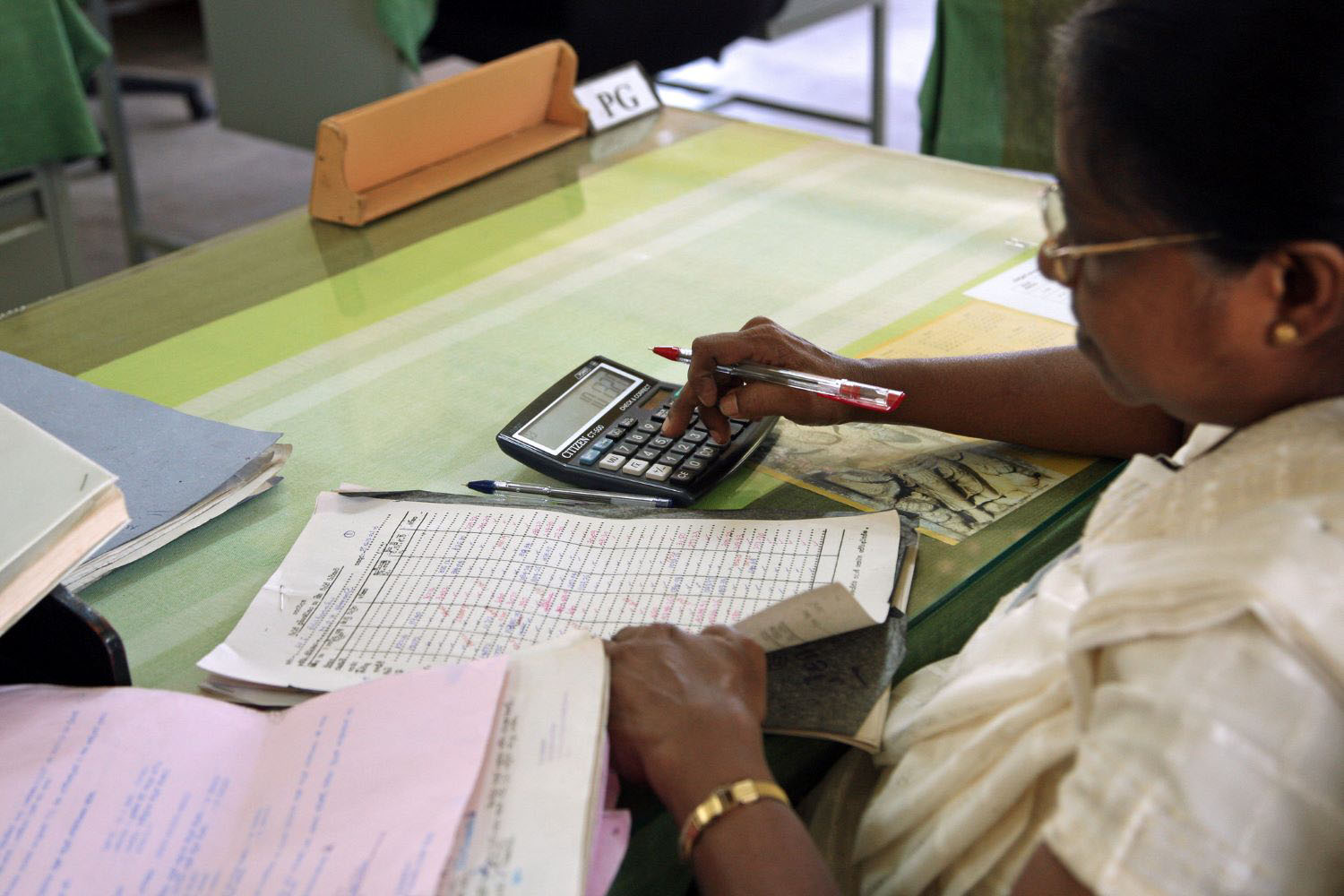 Hospital worker calculating finances