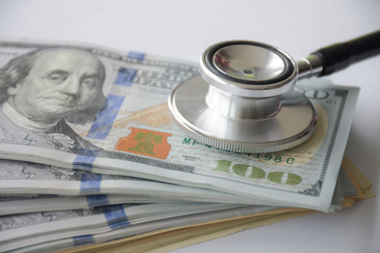 Large amount cash money with stethoscope 