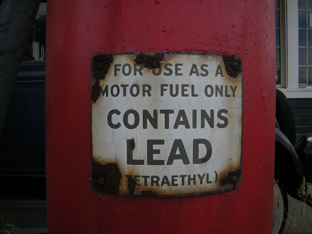 lead warning sign on old gas pump