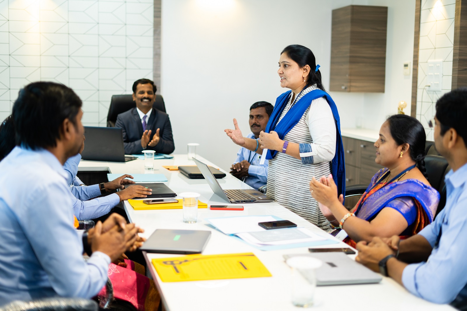 Indian woman addressing a corporate boardroom