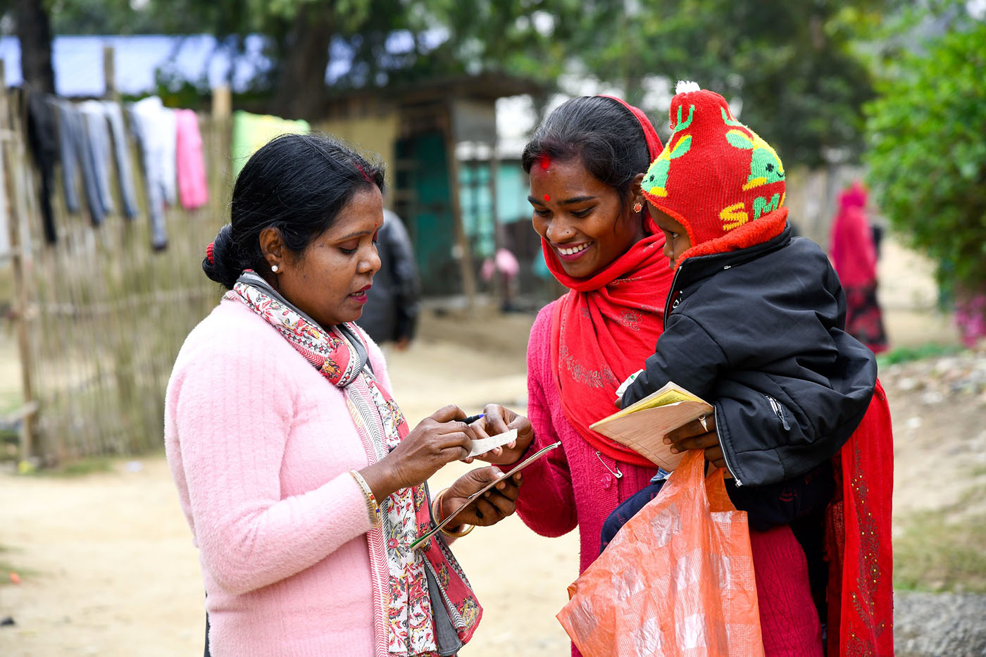 Community worker speaks with woman as part of USAID-supported project in Assam, India