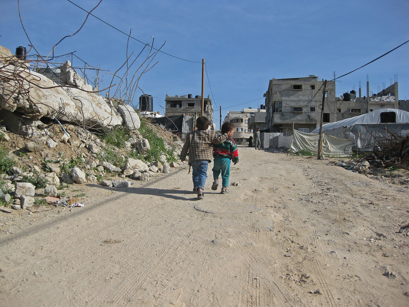 Children walking on a dirt road in Gaza