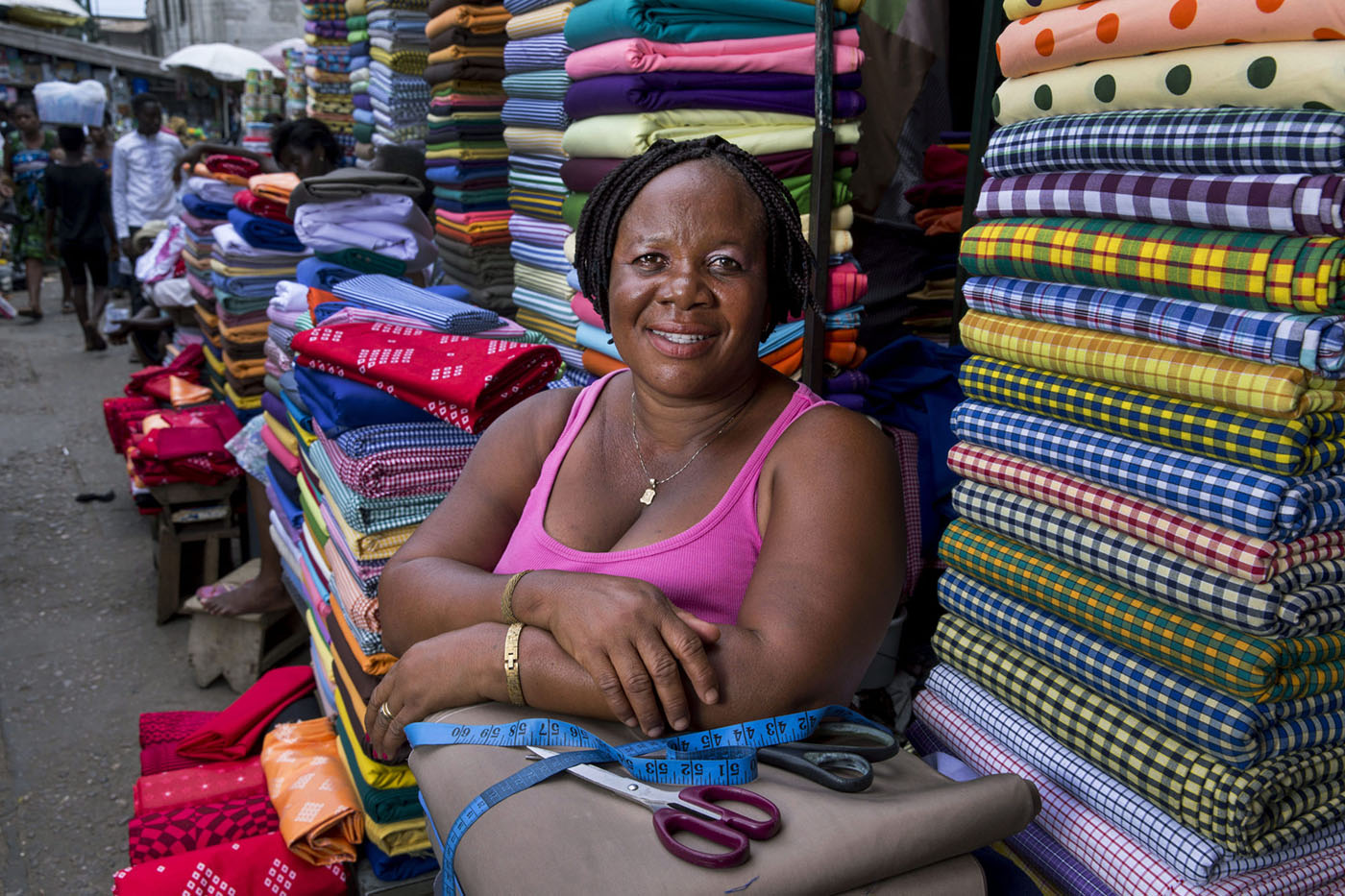 Informal worker sells fabrics in Makola Market in Accra, Ghana.