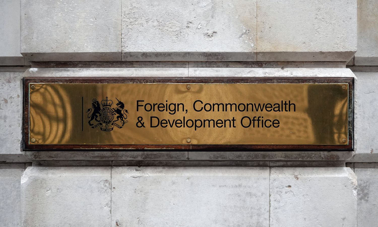 Foreign, Commonwealth and Development Office brass nameplate on wall.