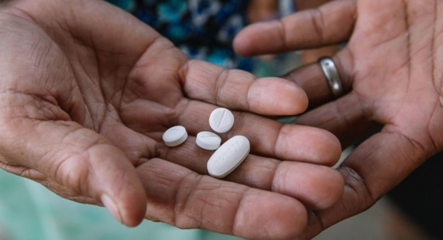 Hands holding medicine pills. 