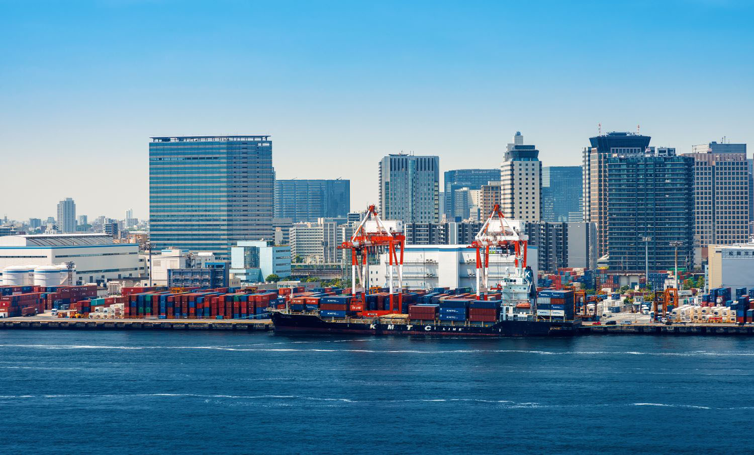 A busy Tokyo port cargo dock in Odaiba, Japan.