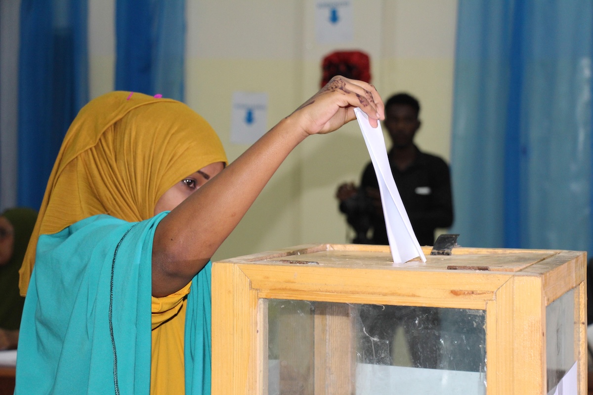A delegate casts her vote at an election in Somalia