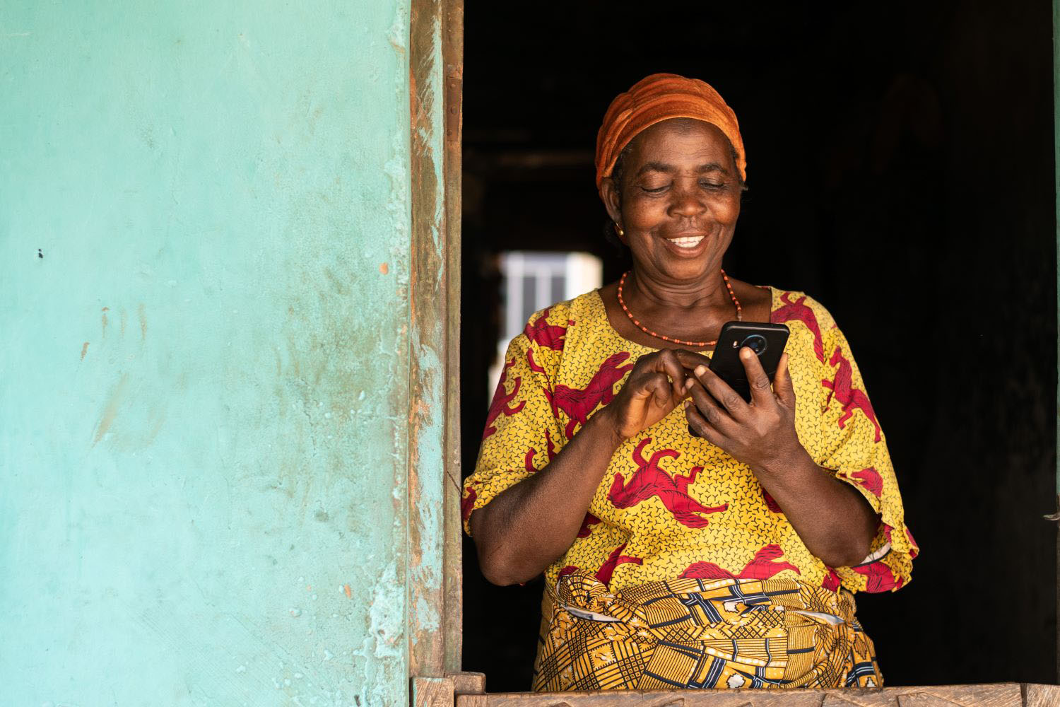 Elderly African woman using her phone