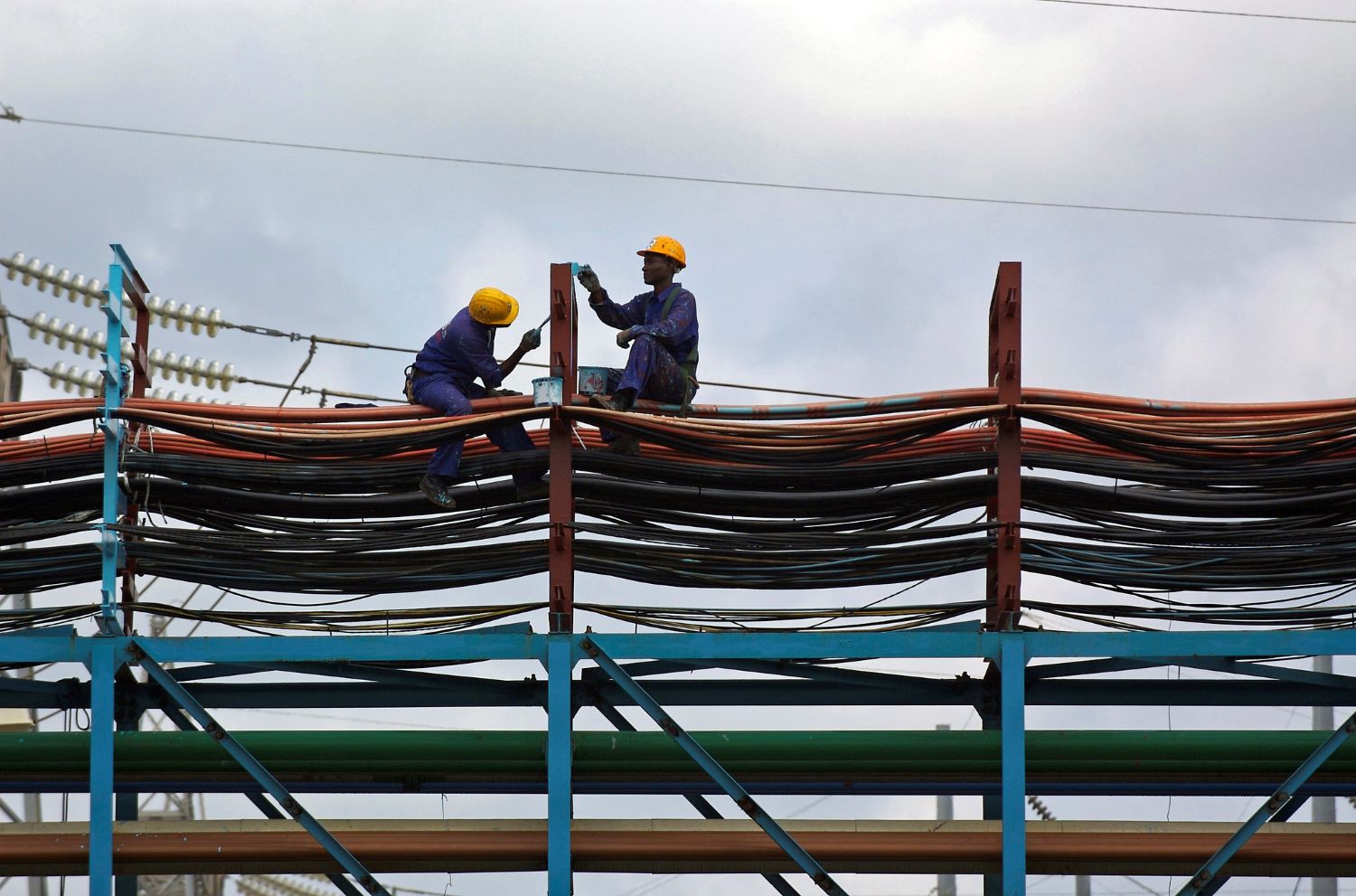 Workers maintain the thermal power station at Takoradi, Ghana, June 21, 2006