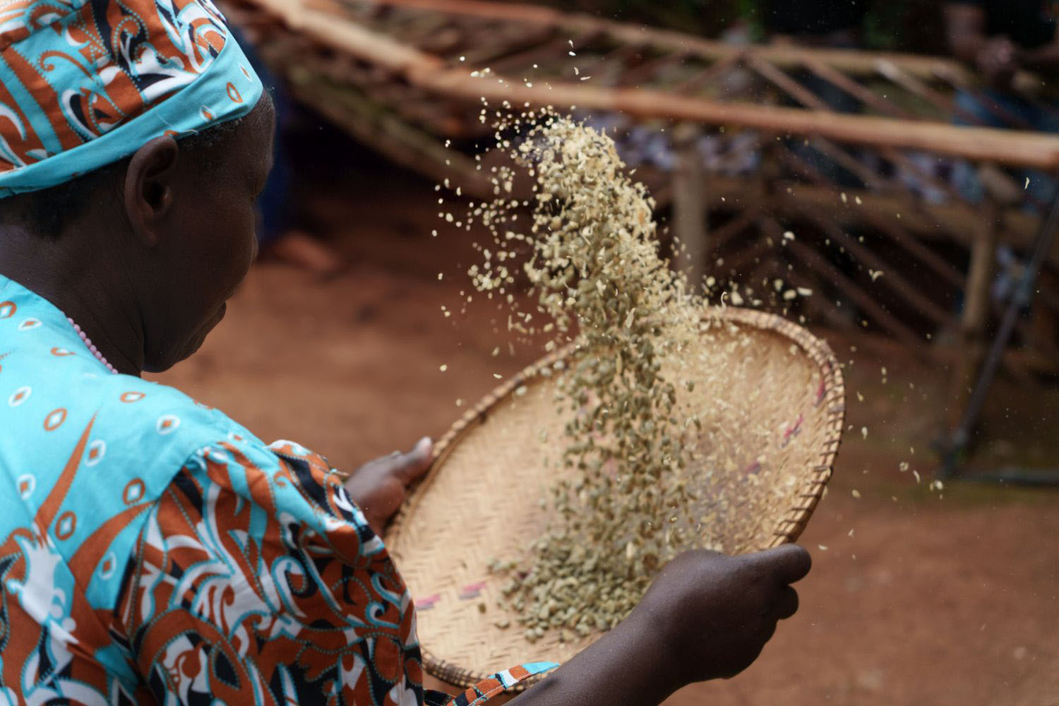 Woman tossing produce in a woven basket