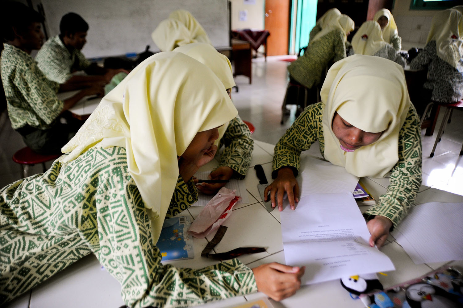 School children working together in the classroom in Indonesia