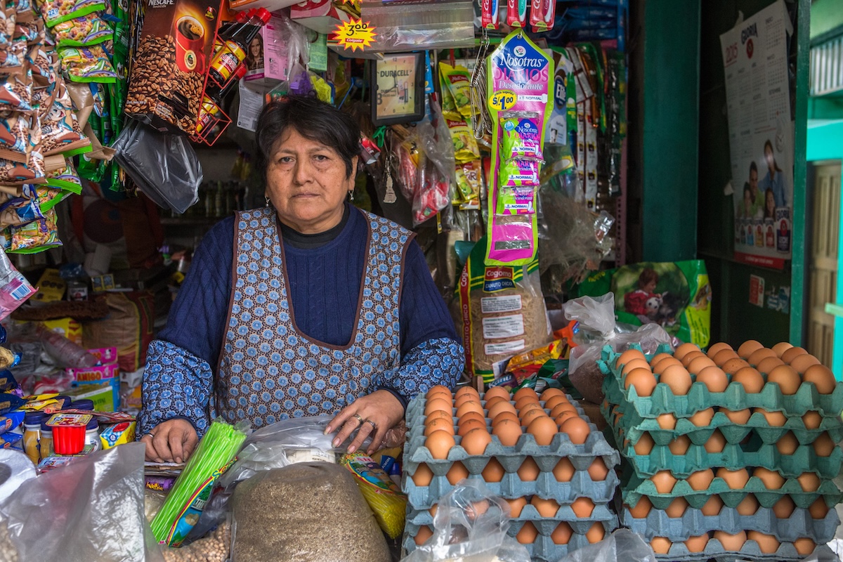 A woman who runs a shop at a market in Lima