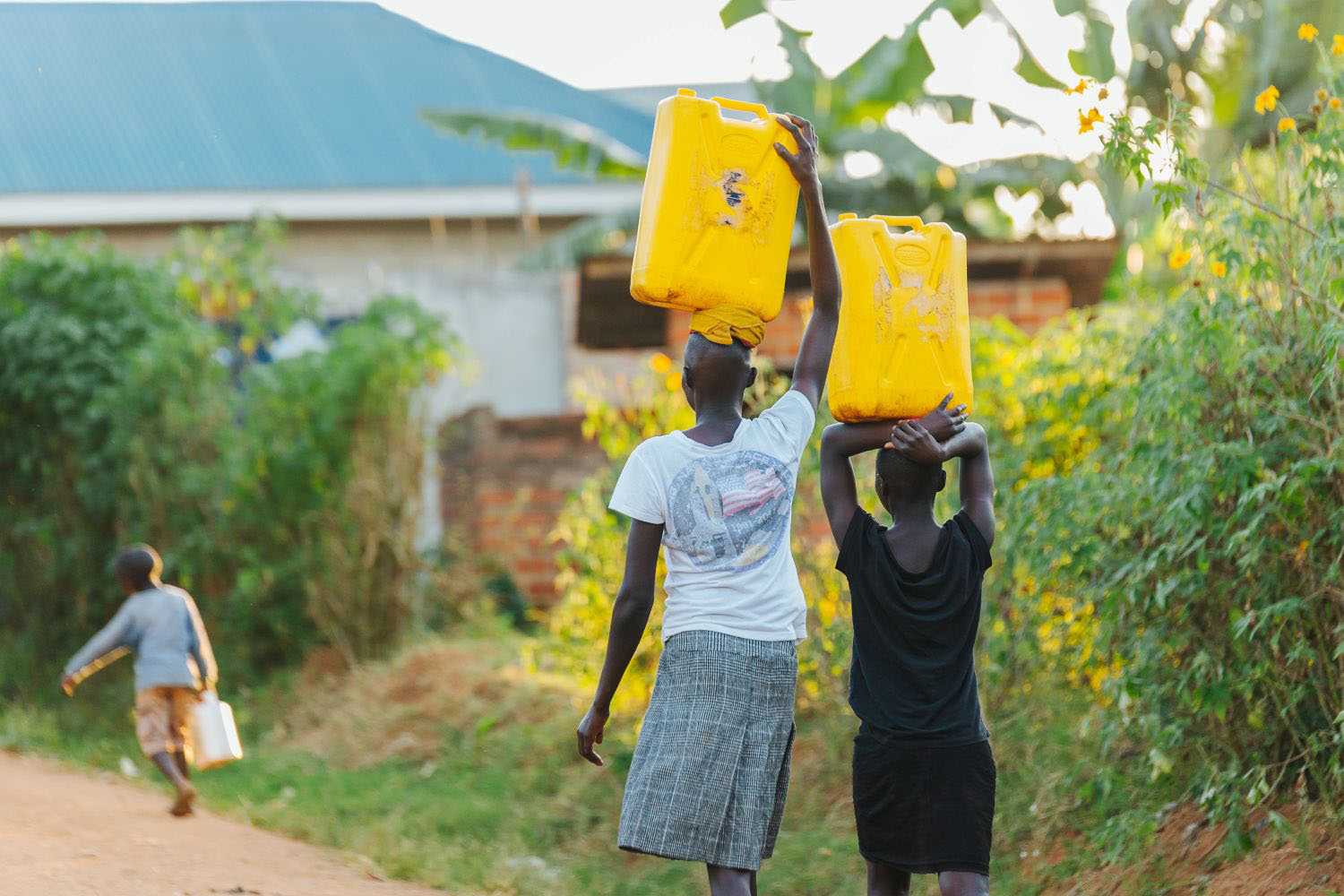 Women carrying water cans in Uganda, Africa