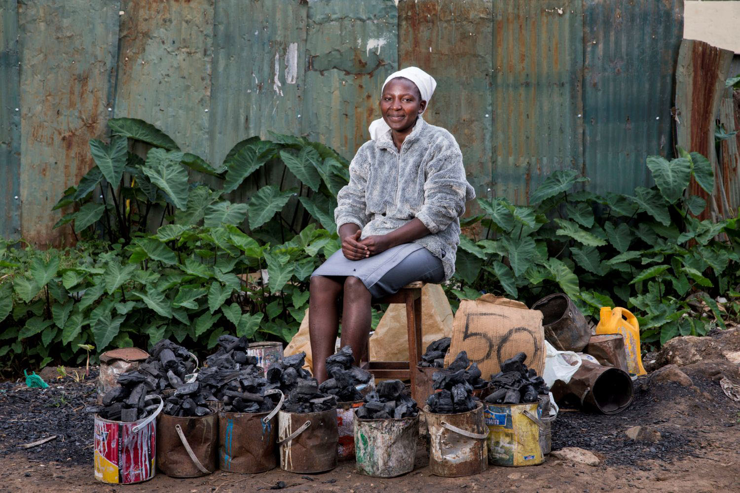Woman selling charcoal on a roadside in Kenya