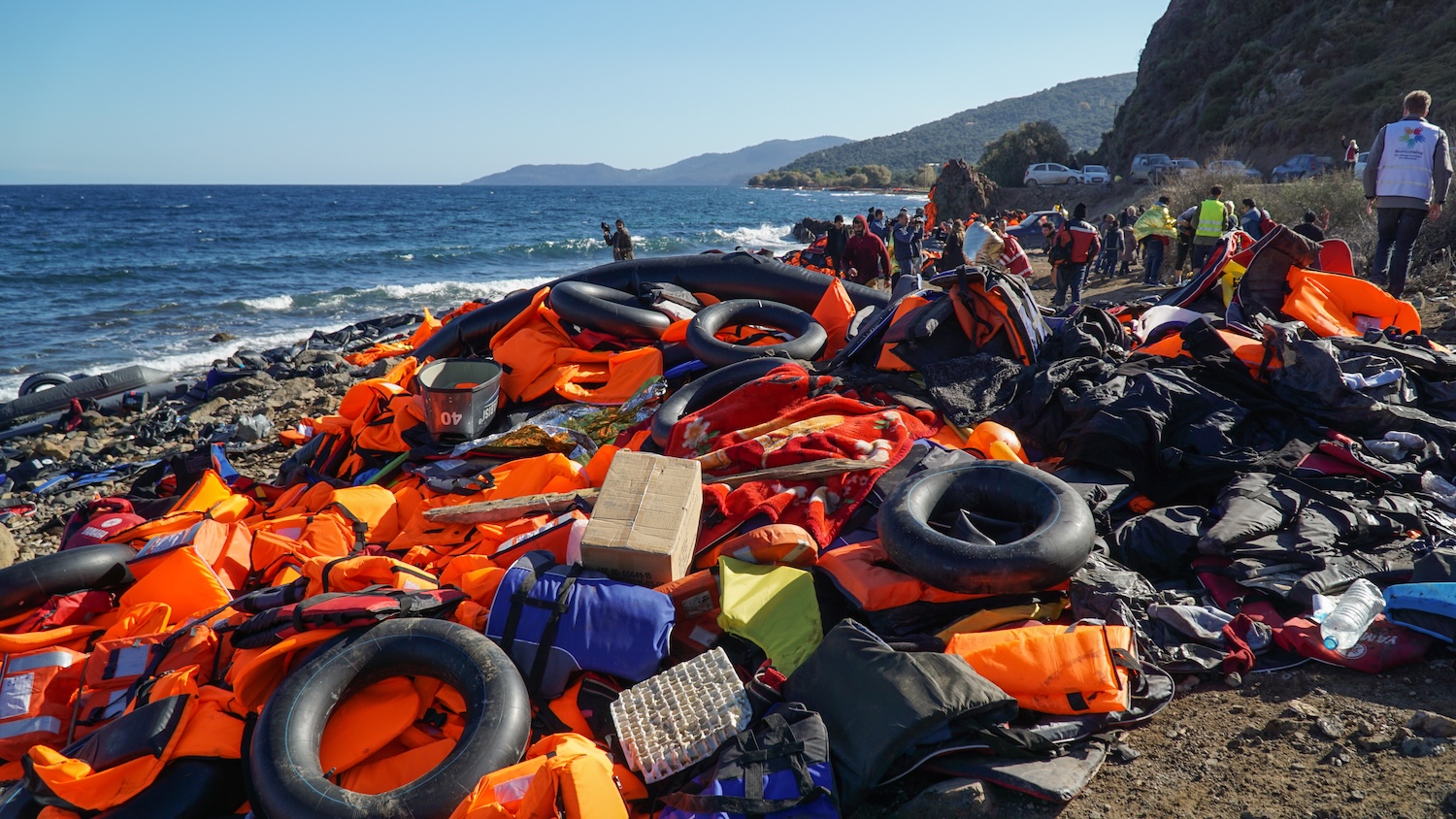 Abandoned belongings and life jackets on the Lesvos shore
