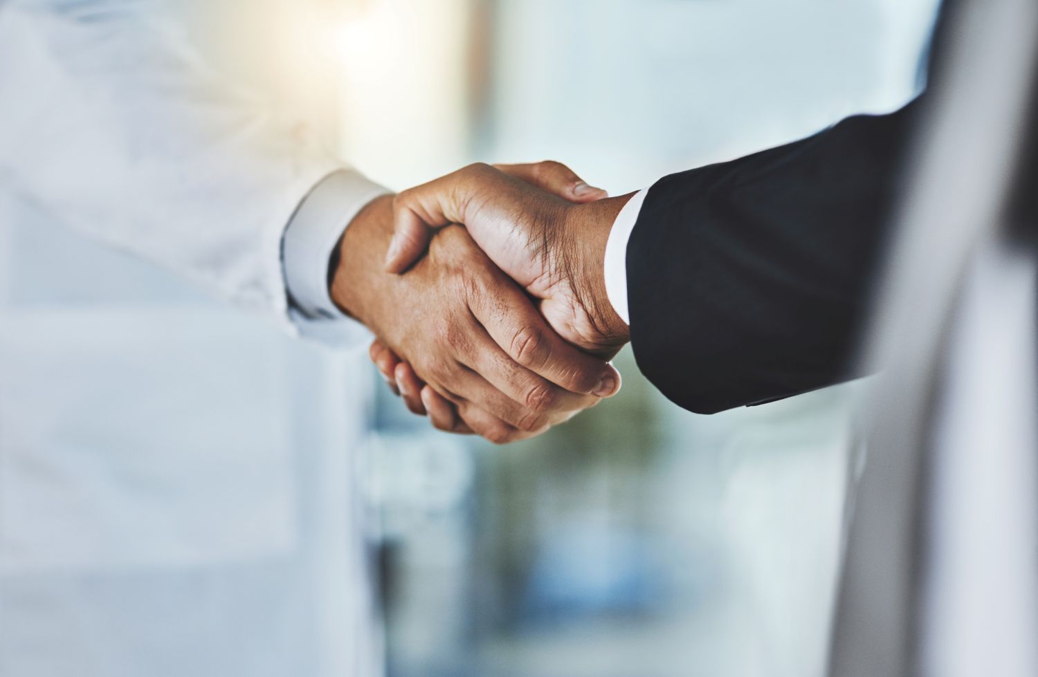  Cropped shot of a doctor shaking hands with a businessman in a hospital