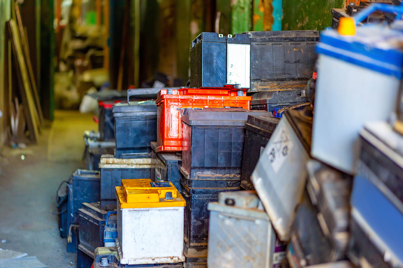 Discarded car batteries for recycling in a lead scrap yard.