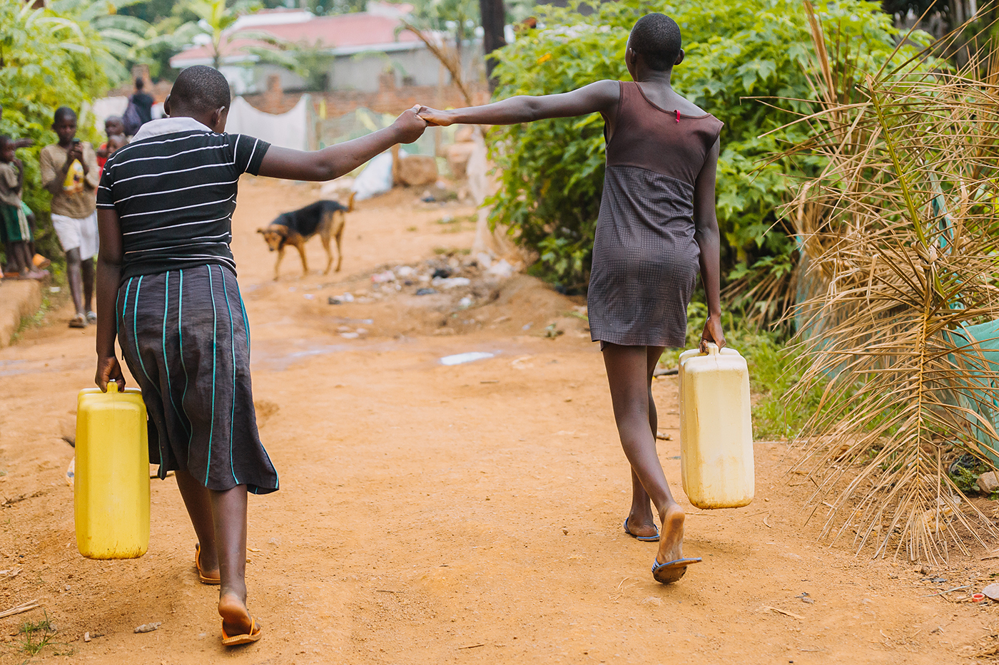 Girls carrying water in rural Uganda