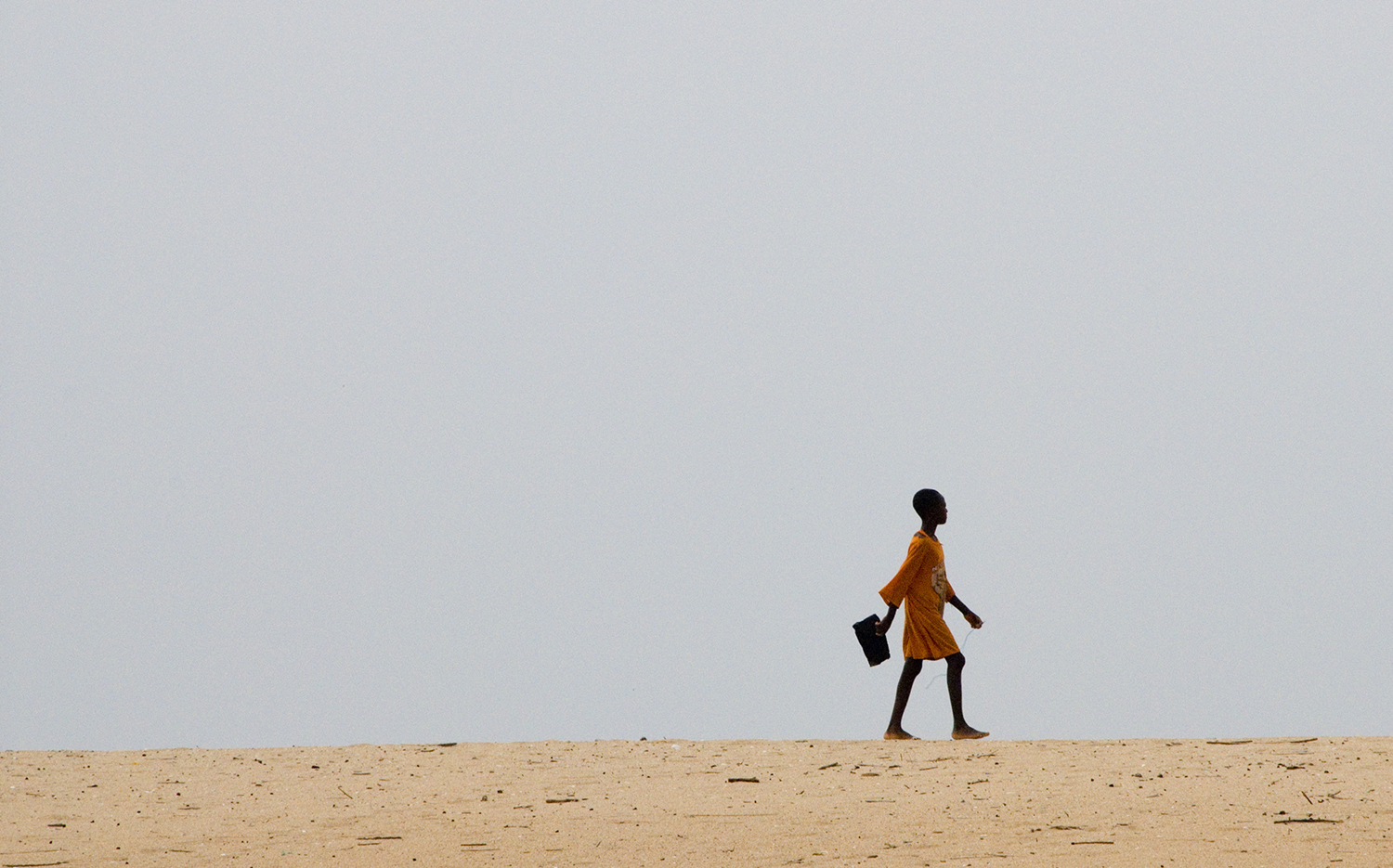 Young girl walking alone to school 