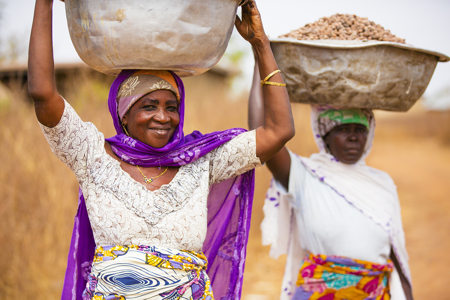 Women carrying shea butter in Ghana