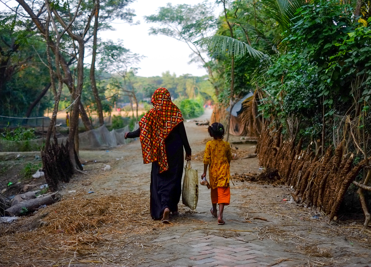 Woman and child walking in rural Bangladesh