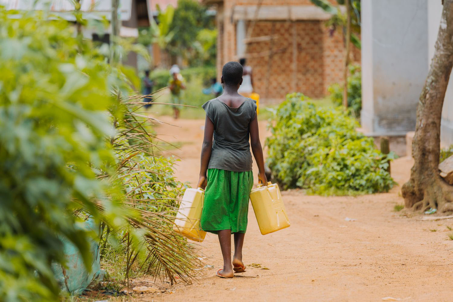 Woman carrying water in Uganda, Africa