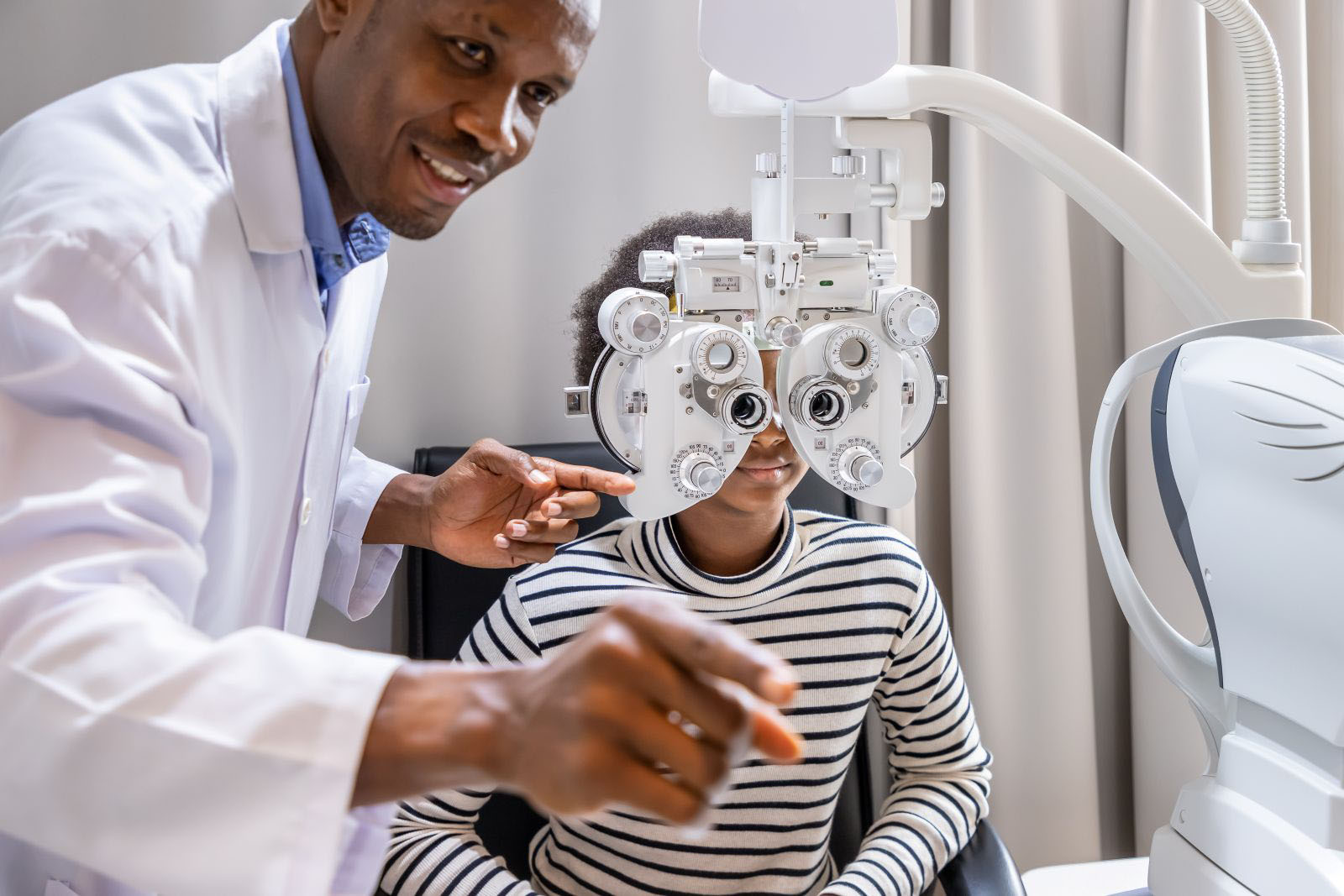 Doctor doing eye test examination on young girl