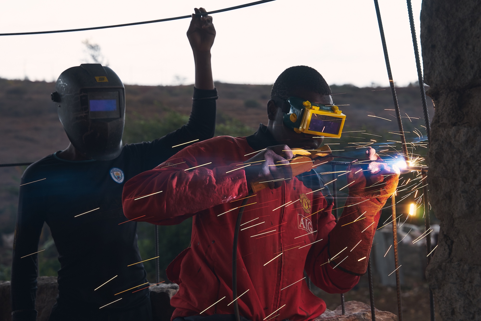 Young man welding steel