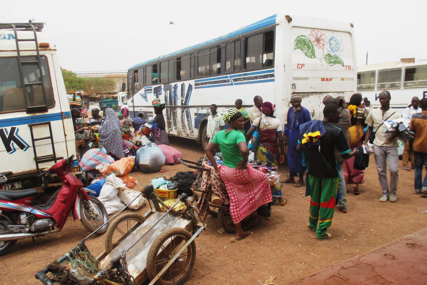 Passengers with multiple items waiting at bus terminal