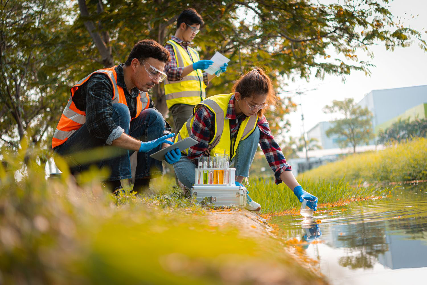 Environmental scientists collect water samples for analysis and research on water quality