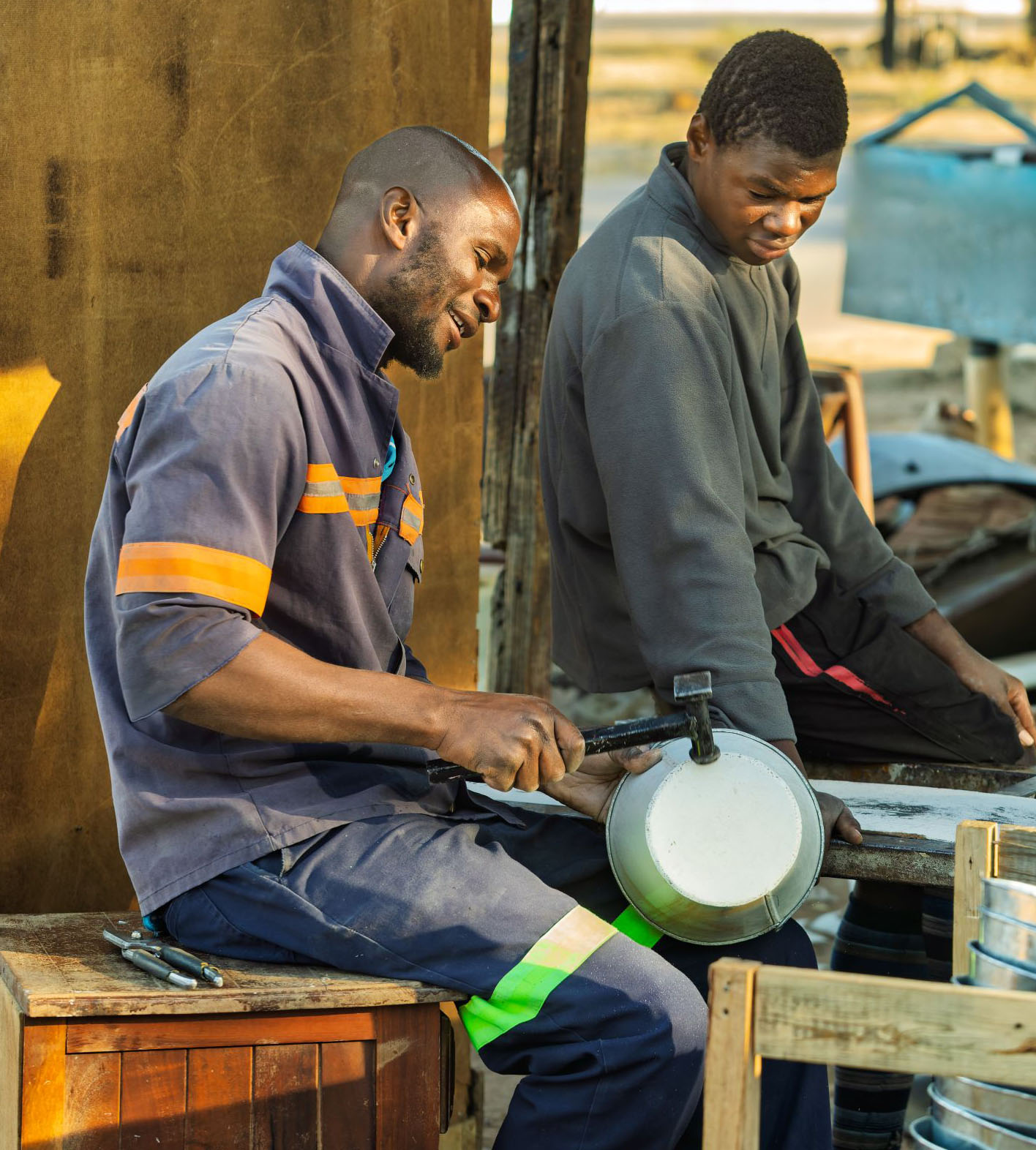 African tinsmith producing local metalwork 