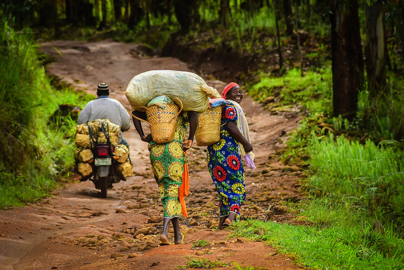  Women carry their wares in woven baskets as they ascend a hill on the way to the market on the Mambilla Plateau in Taraba state, Nigeria
