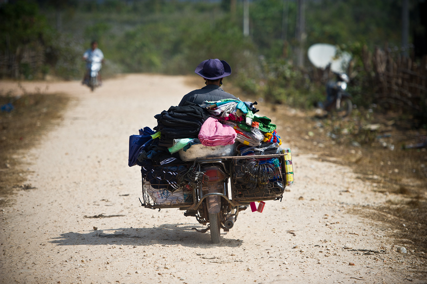 Motorist goes to the market through the new roads built under the GMS Nam Theun 2 Hydropower Development Project, Lao PDR